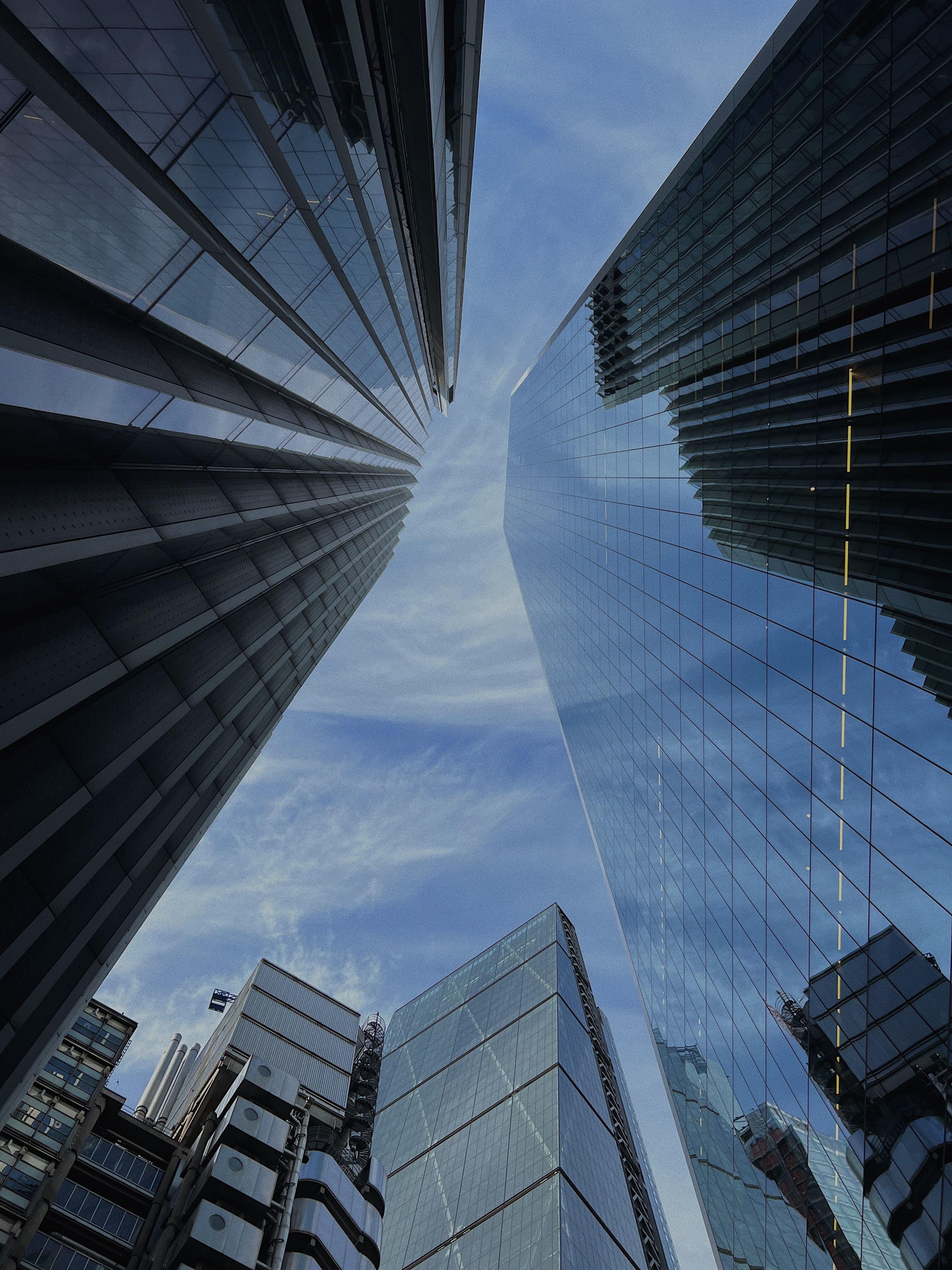 Looking up between glass towers in the City of London